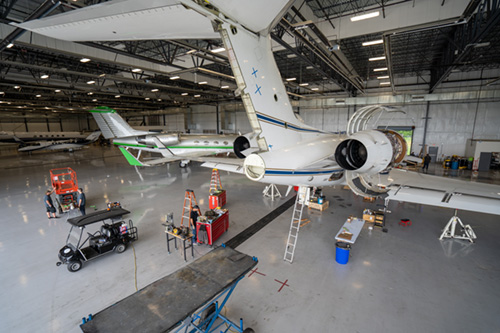 Multiple jets receiving maintenance in hangar