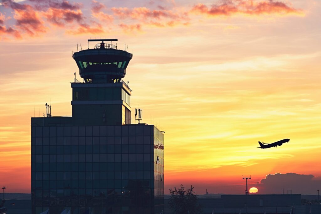 Air Traffic Control Tower at the airport during amazing sunset.