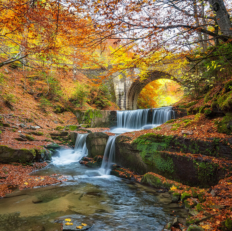 Autumn river with beautiful cascades of water and an old bridge near Sitovo village, Bulgaria