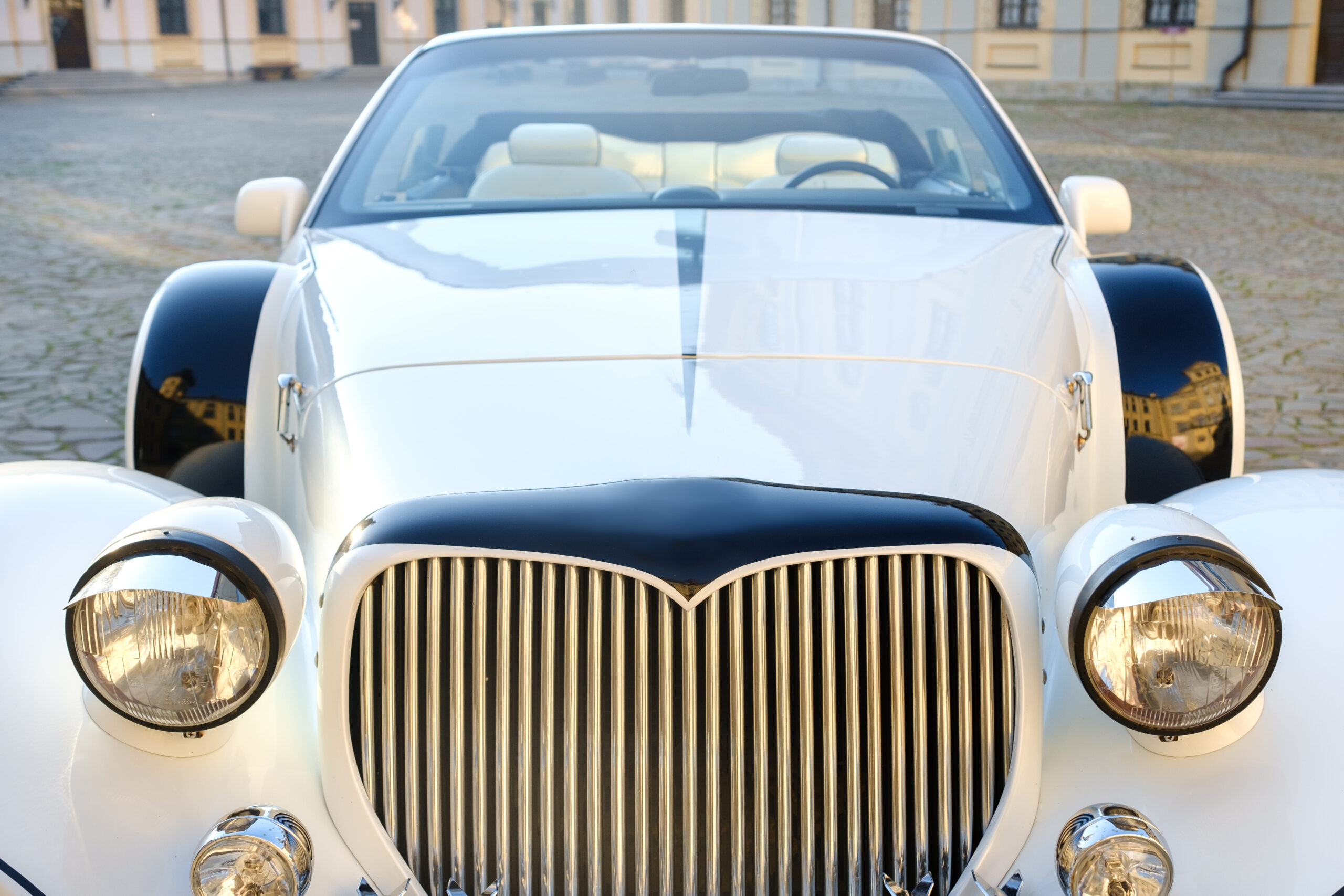 White vintage car in castle courtyard