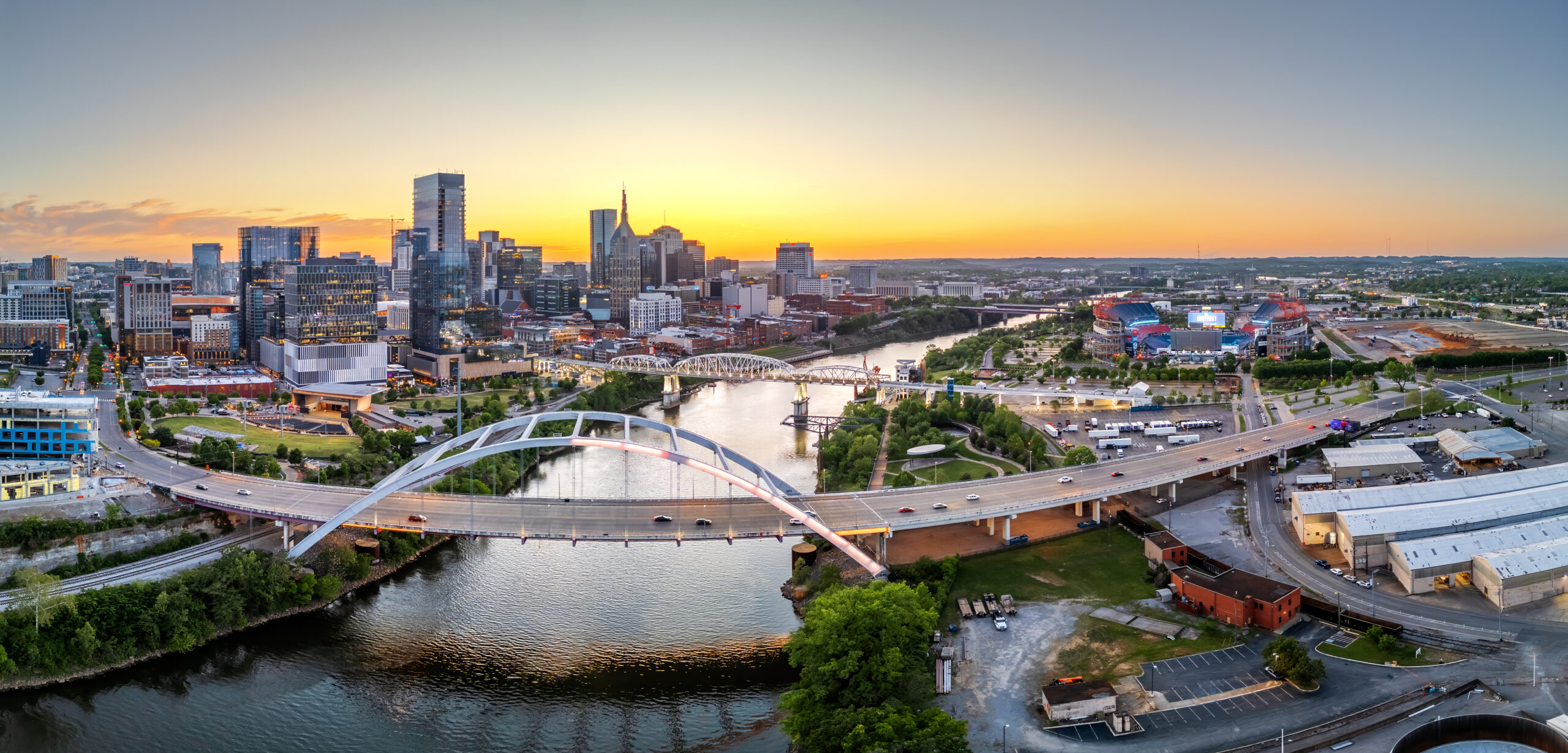 Nashville, Tennessee, USA skyline over the Cumberland River at golden hour.