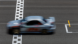 Blurred race car crossing finish line