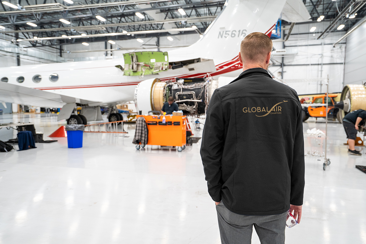 Global Air Charters employee surveying jet maintenance programs