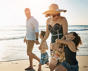 Excited family spending time on beach in Turks & Caicos