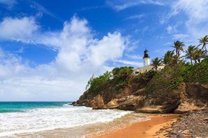 Puerto Rico coastline beach at Punta Tuna lighthouse with a blue sky and clouds