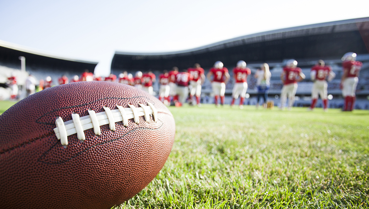 Close up of an american football on the green field, Super Bowl in New Orleans