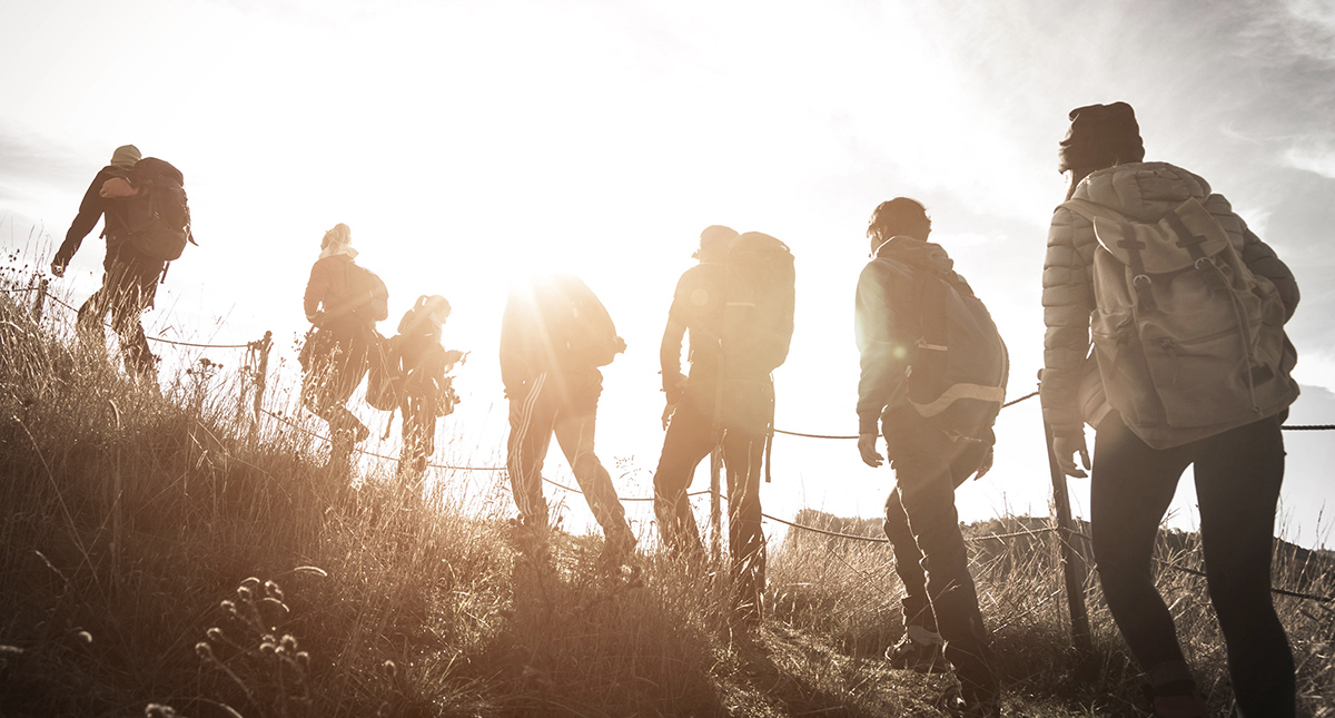 Group mountaineers using technical climbing skills for their adventure travel resolutions