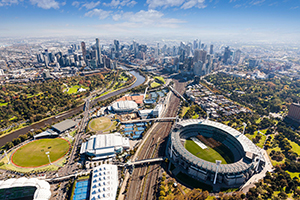 Aerial view of Melbourne park complex with cityscape in background