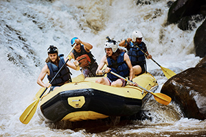 team of individuals white water rafting